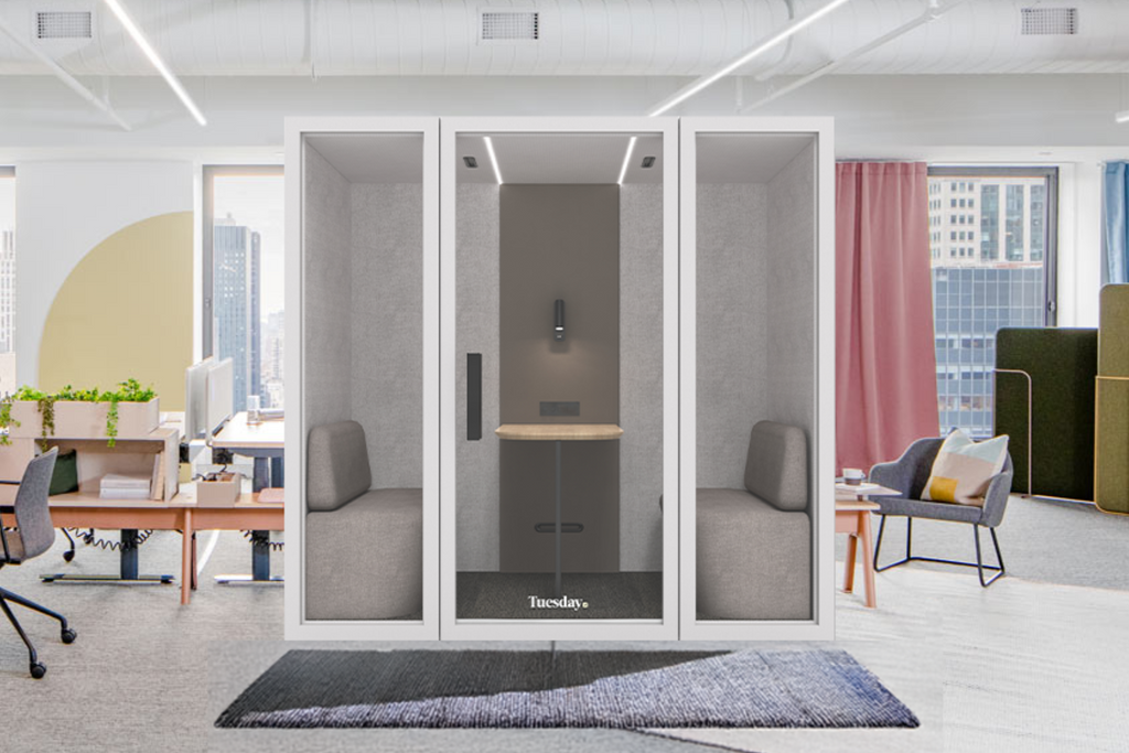 A soundproof Tuesday booth in an office setting, showcasing its sleek, acoustic design perfect for enhancing privacy and focus in professional environments.